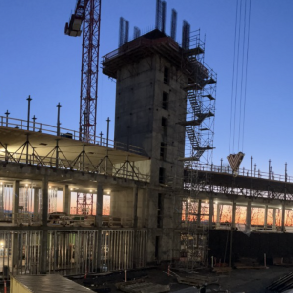 the towers of the new student housing building under construction at sunset