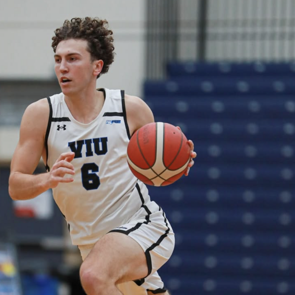 viu men's basketball team member running with the ball in their hand during a game