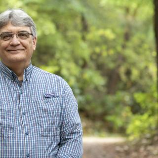 VIU Forestry Professor Bill Beese stands in front of trees.
