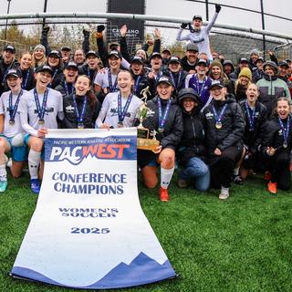 VIU Mariners women's soccer team with championship banner