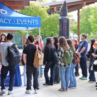 Students stand in front of a tent outside the Cowichan campus