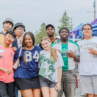 Group photo of students with tents in the background