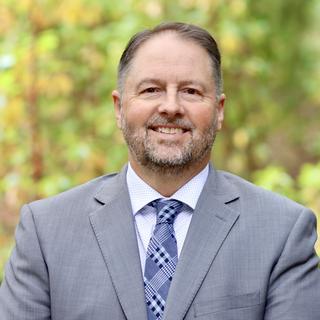 Dennis Johnson with a forest background