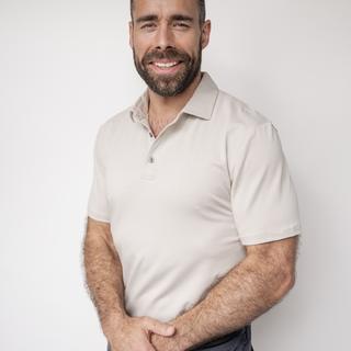 Jake torso and up portrait against a white wall