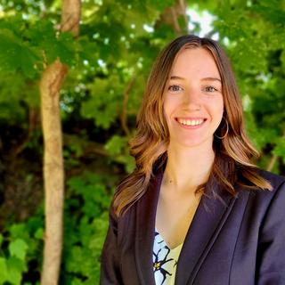 Megan Fortune in front of green foliage