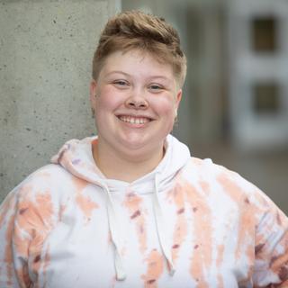 Tatum poses in front of a grey wall