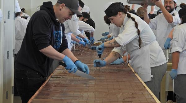 Students cut the large Nanaimo bar