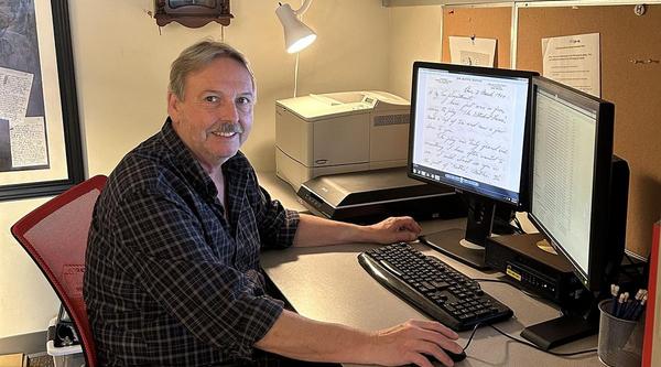 Stephen sits at his computer