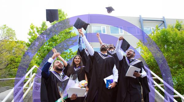 Grads throw their caps in the air