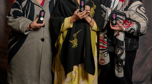 group of people holding awards