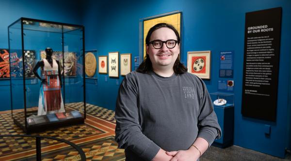 Eliot stands in front of his exhibit at the Museum of Natural History