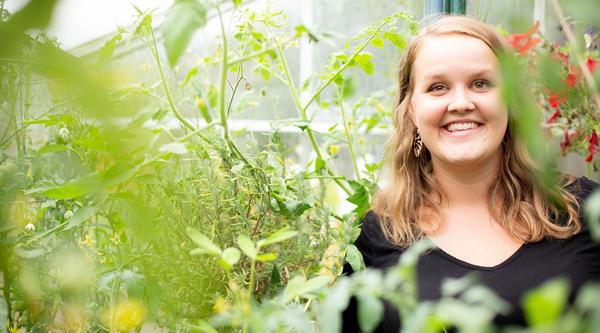 Profile of Bianca van der Stoel in a greenhouse surrounded by plants