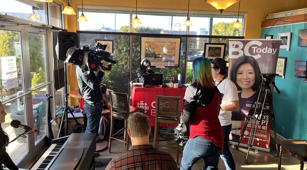 People doing a live broadcast in a coffee shop