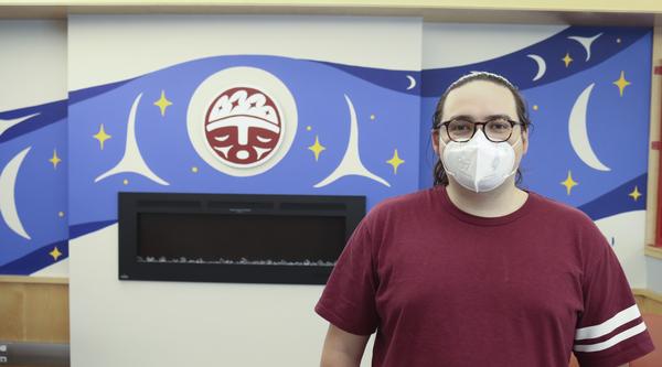 Eliot posing in front of the mural over the fireplace