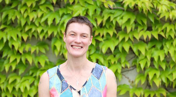 Emily Huner stands in front of foliage at VIU's Nanaimo campus