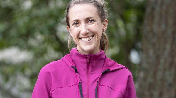 Haley Healey head and shoulders with a forest background