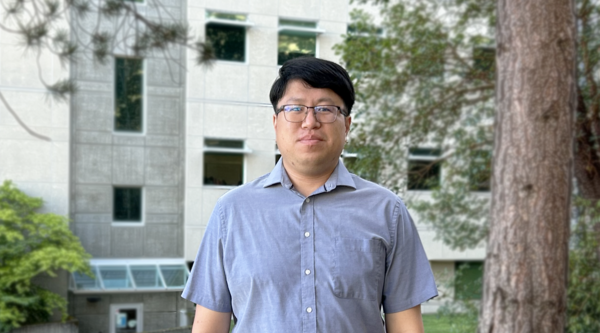 Cliff Feng standing outside of a building at VIU and looking at the camera.