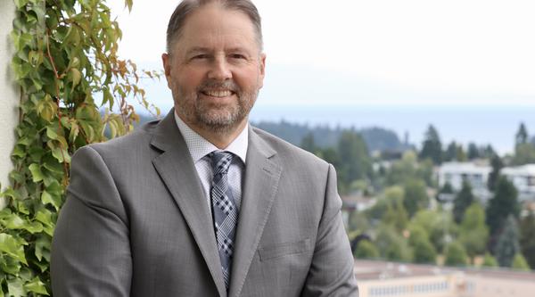 Dennis Johnson with a view of the Nanaimo campus and greenery behind him