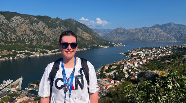 A woman with a beautiful vista view behind her