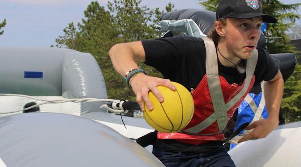 A student runs with a ball
