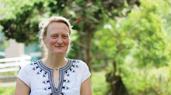 Jenni Ottilie Keppler stands on the koi pond bridge at Vancouver Island University's Nanaimo campus.