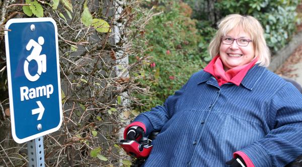 Dr. Linda Derksen with a ramp sign