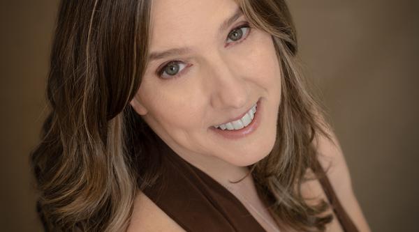 Margot Fedoruk smiles at the camera wearing a halter top