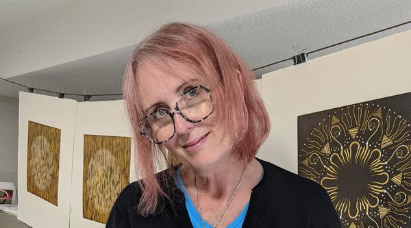 Mary Anne Molcan stands by her print press.