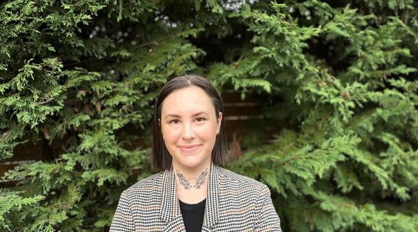 Morgan in front of green bushes