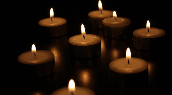 Closeup of lit candles in a dark area