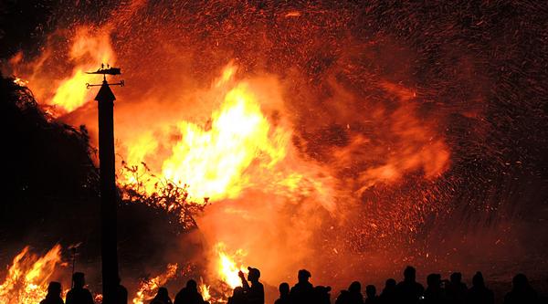 Wildfire with silhouettes of people looking on