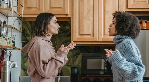 Two women argue in a kitchen