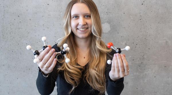 Savannah Mercer holds up DNA models