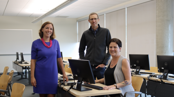 From left to right: Tracy Vandermolen, Darrell Harvey and Anwen Burk in a computer lab and smiling at the camera