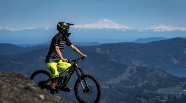 A mountain biker takes in the views on a sunny day