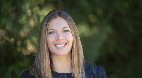 Serene Kerpan head and shoulders with greenery behind her