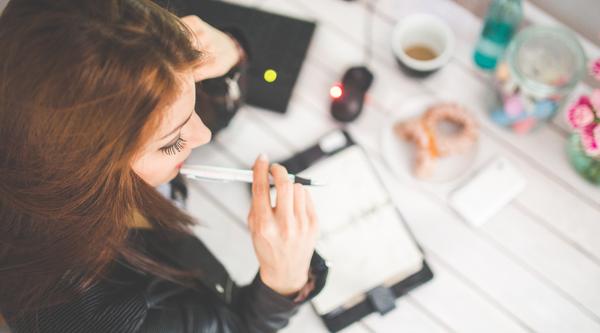 Woman at desk with books in front of her