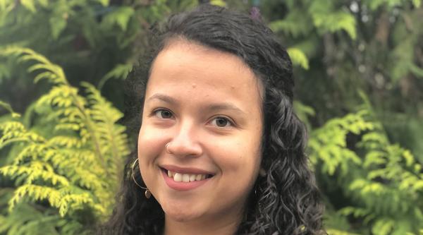 Portrait photo of Taylor in front of some foliage