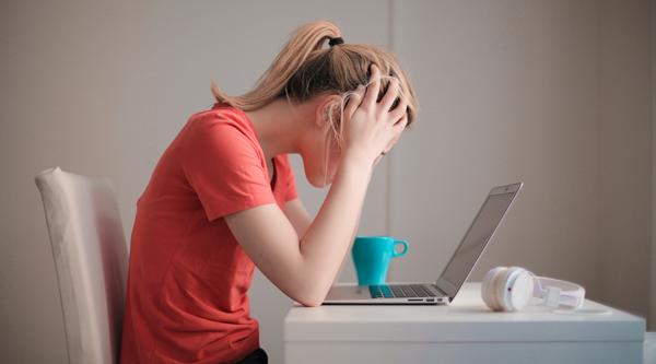 Student sitting at a desk in front of a laptop