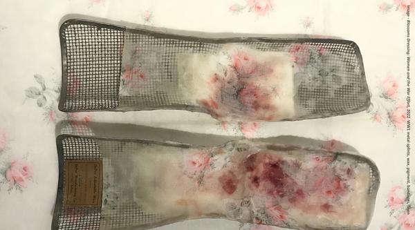 Blossoms Dressing by Cindy Stelmackowich consisting of metal splits with wax, pigment, bandages and linen.