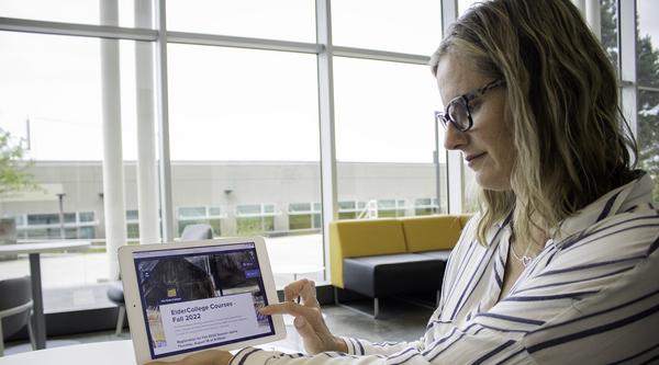 Regan McKeever uses an iPad to view the VIU ElderCollege website.