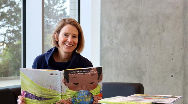 A woman reading childrens picture books 