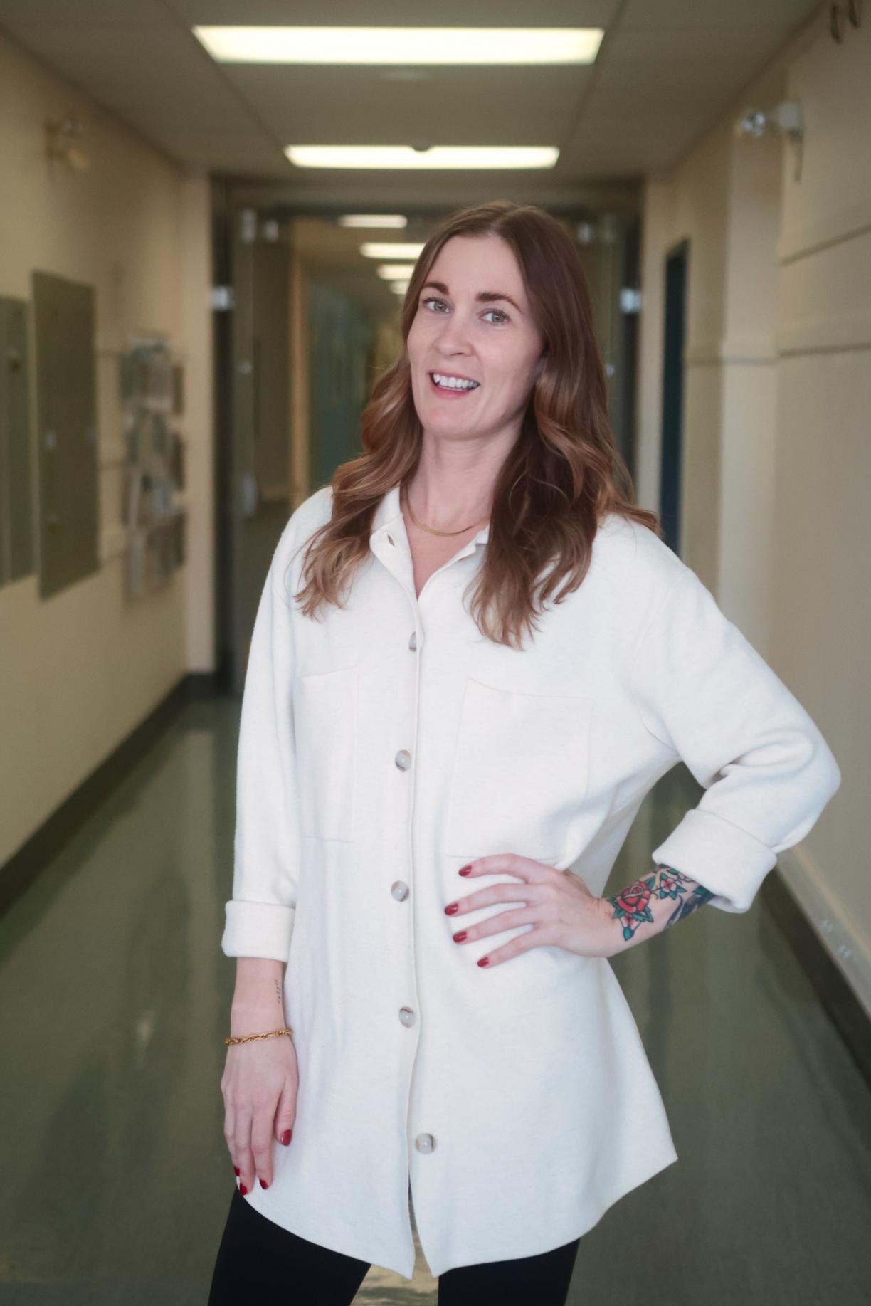 Shauna stands in the hallway