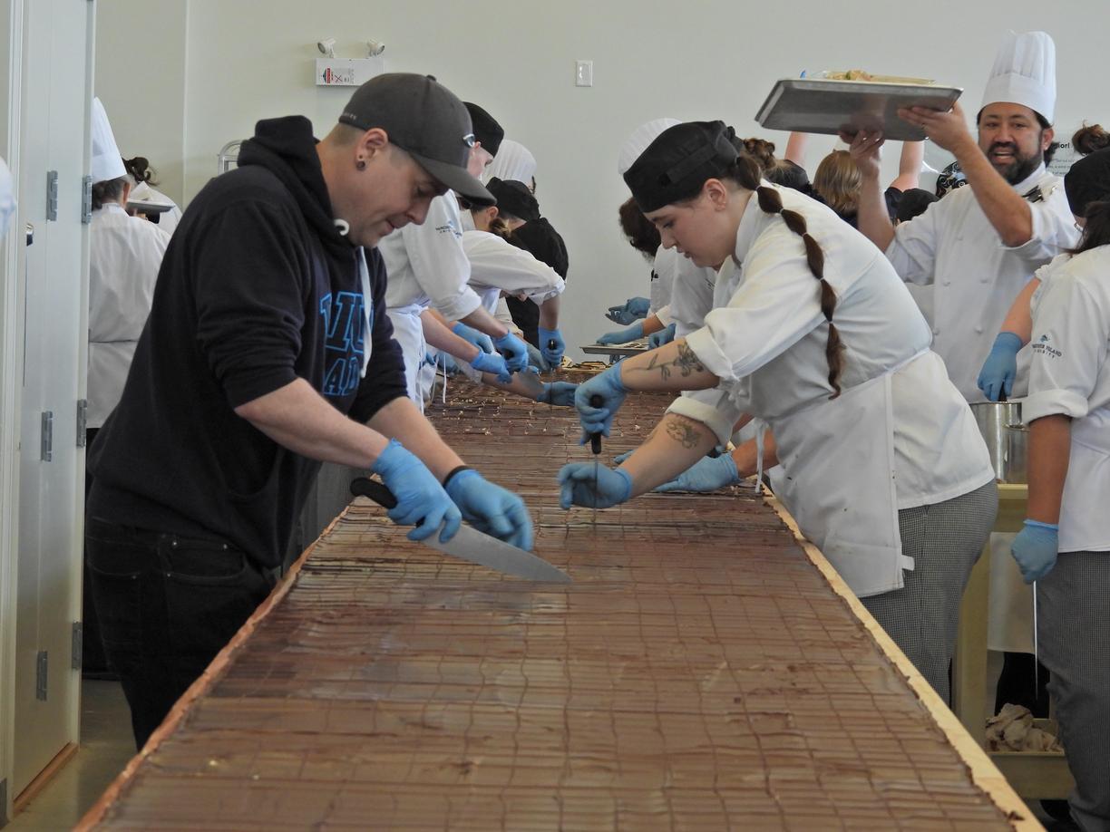 Students cut the large Nanaimo bar