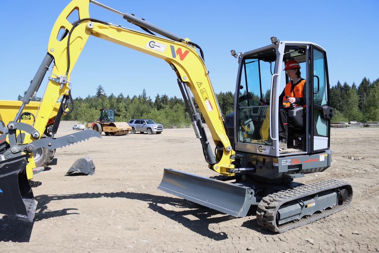 a person operates an excavator
