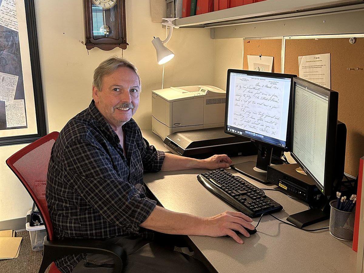Stephen sits at his computer