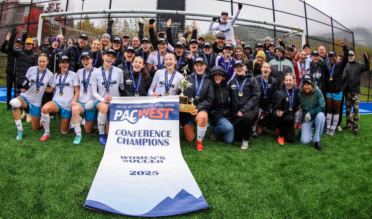 VIU Mariners women's soccer team with championship banner