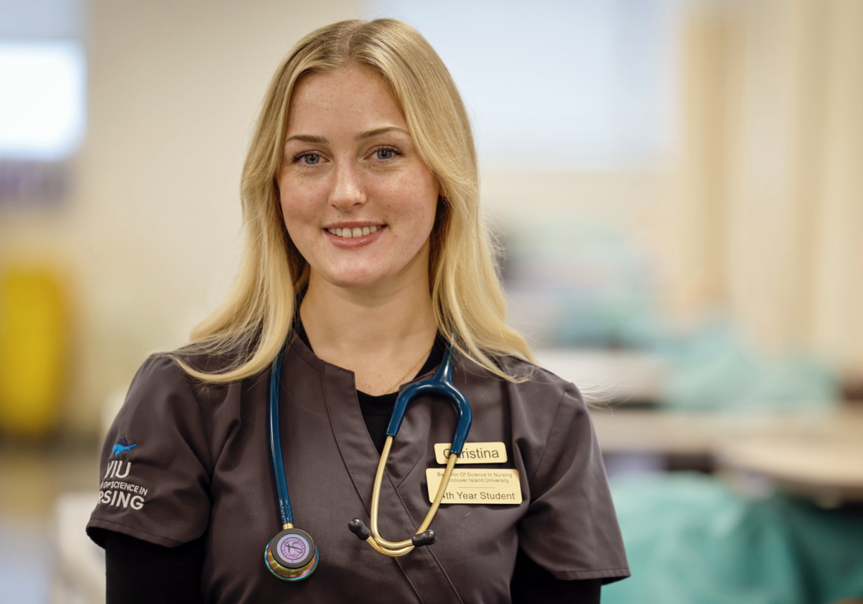 Christina smiling at the camera while wearing a VIU Nursing shirt.