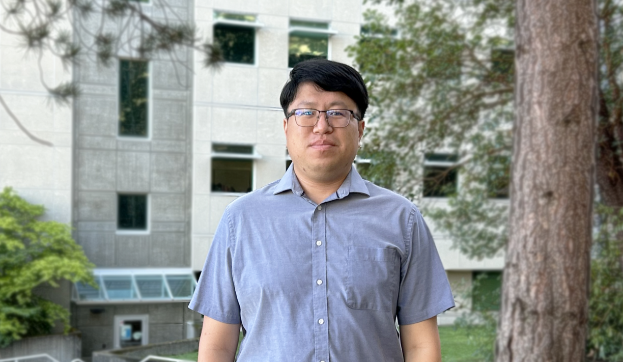 Cliff Feng standing outside of a building at VIU and looking at the camera.