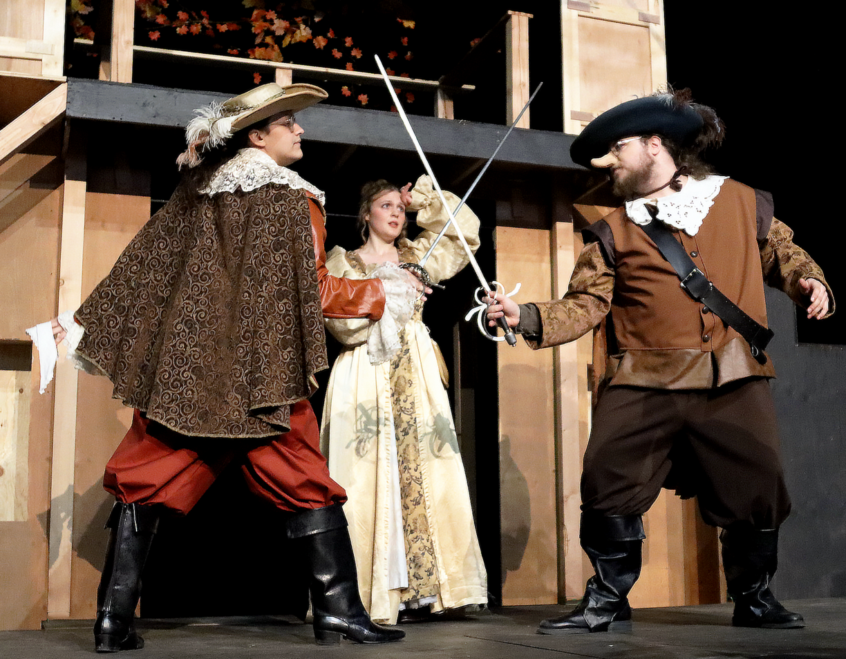 Three of the actors stage a swordfighting scene for their production Cyrano de Bergerac.